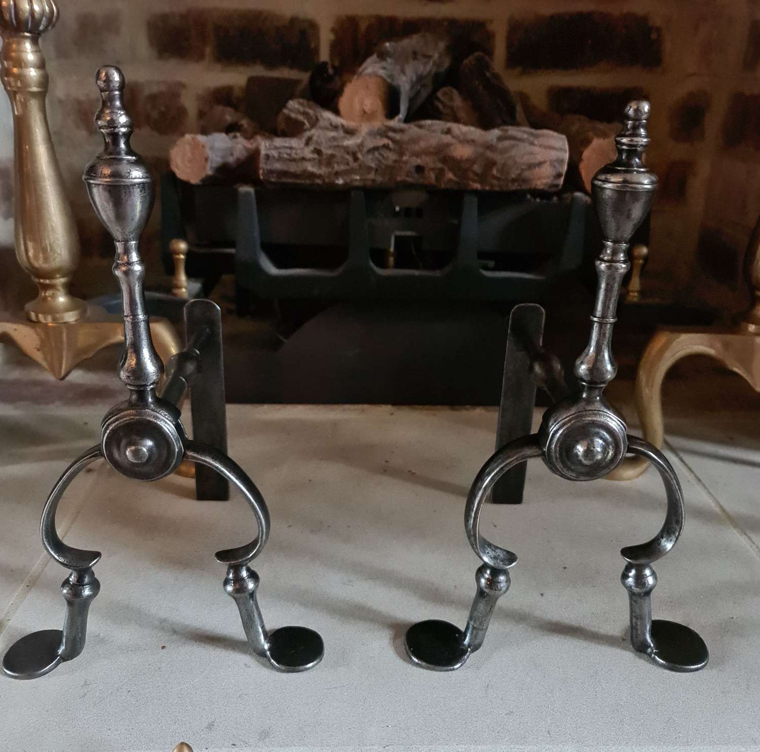 A Pair of George III Burnished Steel Fire Dogs