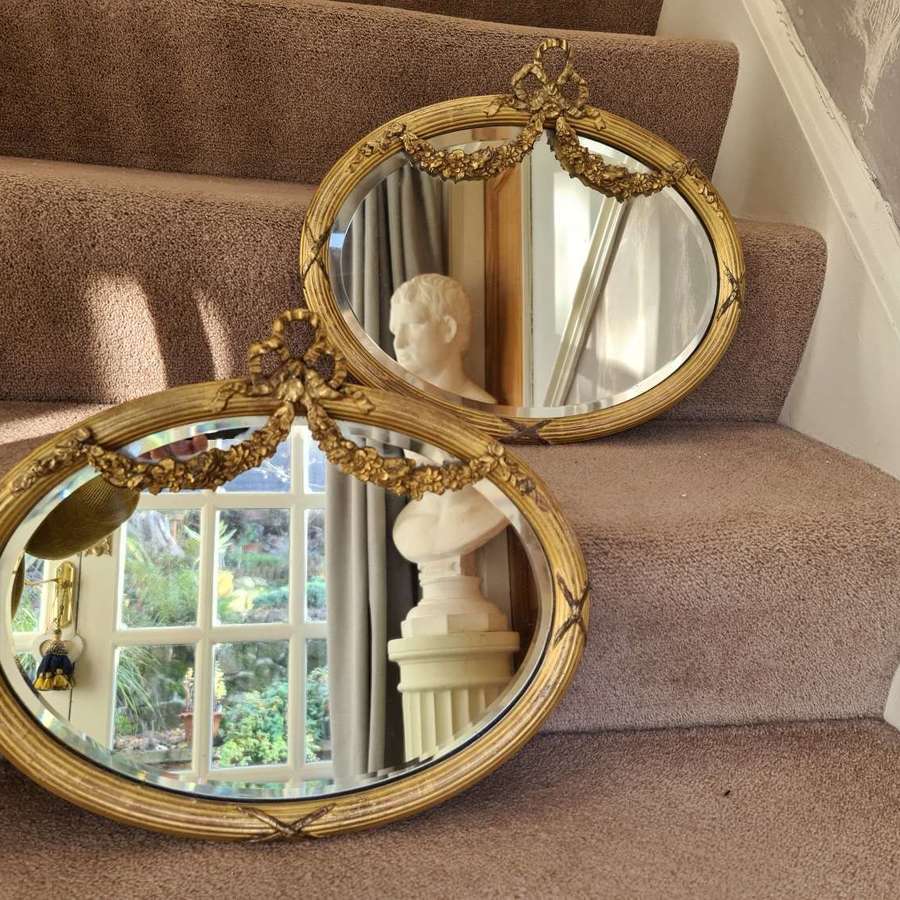A pair of small 19th Century Oval Giltwood Mirrors