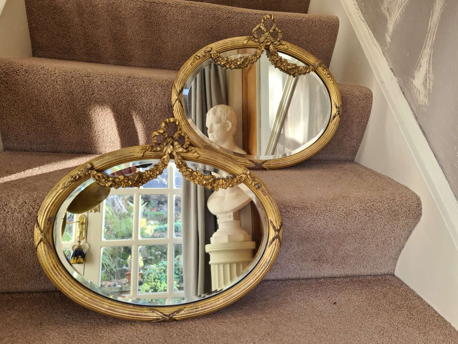 A pair of small 19th Century Oval Giltwood Mirrors